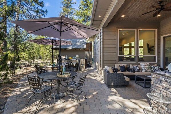 Relax and socialize in this outdoor patio area with a barbecue grill and comfortable seating.