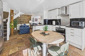 Enjoy meals in this kitchen with stainless steel appliances and a central island.