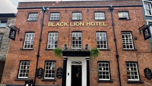 The Black Lion Hotel facade with a traditional brick exterior, multiple windows, and a prominent entrance. - The Black Lion Hotel  (Cardigan)
