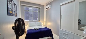 Relax in this stylish room with a comfortable bed, city view, and convenient amenities.