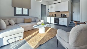 A modern apartment with a living room, kitchen, and dining area. - Parousia Luxury Apartments (Paros)