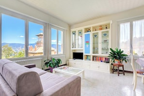 A living room with a sofa, coffee table, and a cabinet with glass doors.