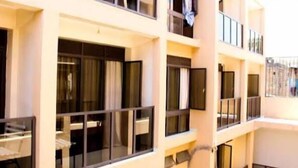 A multi-story hotel with balconies and large windows. - Hotel Twin Towers Homa Bay (Homa Bay)