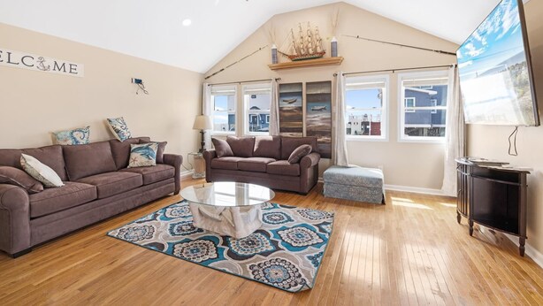 A spacious living room with two sofas, a coffee table, and a patterned rug. - Reeds beach retreat 2 bedroom with water view (Reeds Beach)