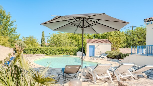 A pool area with lounge chairs and an umbrella. - Lou Vaou - Maison Climatisée avec Piscine (Carcès)
