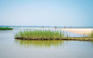 Enjoy a serene beach experience with a gentle slope leading to the calm waters.