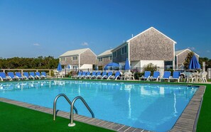 Relax by the pool surrounded by comfortable seating and lush surroundings.