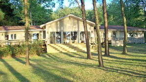 A two-story house with a large front porch and a covered entryway.
