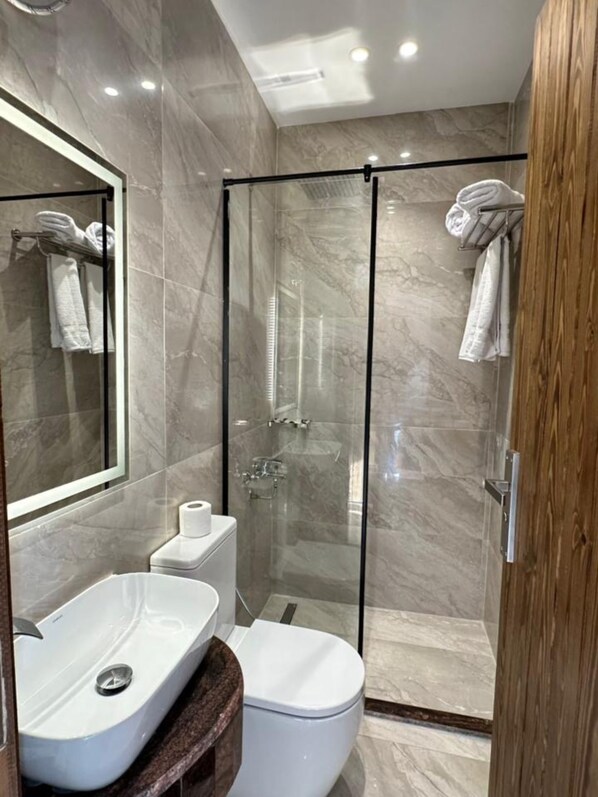 A modern bathroom with a glass-enclosed shower, a white sink, and a toilet. - Elevana Boutique hotel (Cairo)
