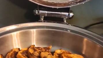 A stainless steel pan with sliced food items.