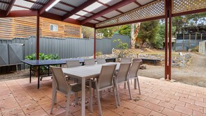 Enjoy an outdoor space with a covered seating area and potted plants.
