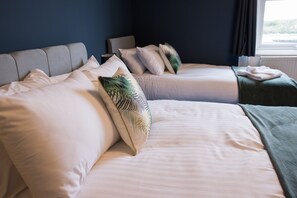 A hotel room with two beds, each with white linens and decorative pillows. - Arbeia in South Shields (South Shields)
