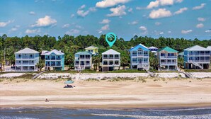 A beachfront property with multiple two-story houses, each featuring balconies and a beach view. - Perfect Timing- On The Beach, Sleeps 10 (Port St. Joe)