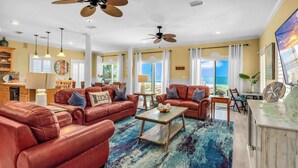 A spacious living room with leather sofas, a coffee table, and a view of the ocean. - Perfect Timing- On The Beach, Sleeps 10 (Port St. Joe)