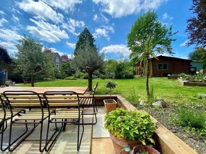 Relax on the patio surrounded by a lush garden and enjoy the peaceful atmosphere.