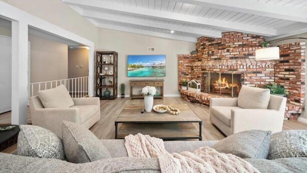 A living room with two sofas, a coffee table, a fireplace, and a TV. - Hidden Paradise｜ BBQ & Fish Pond (Glendora)