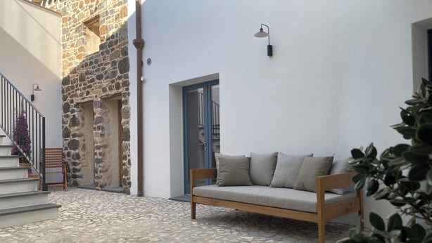 A stone building with a wooden bench and a blue door. - Zenia A - large terrace, sea and mountain view, free private garage (Orosei)