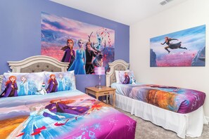 A bedroom with two beds, each with themed bedding, a nightstand, and wall art. - Newly Furnished/Private Pool/Storey Lake 20040 (Kissimmee)
