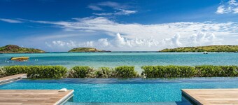 An exceptional beachfront villa with a heated infinity pool