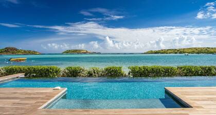 An exceptional beachfront villa with a heated infinity pool