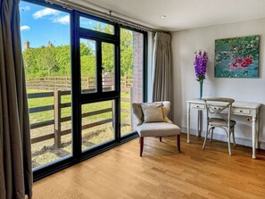 A room with a large window, a desk, a chair, and a painting on the wall. - Barn Owl Cottage - UK48510 (Kirk Hammerton, near York)