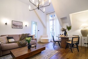 Un salon moderne avec un canapé, une table basse et un coin repas.
