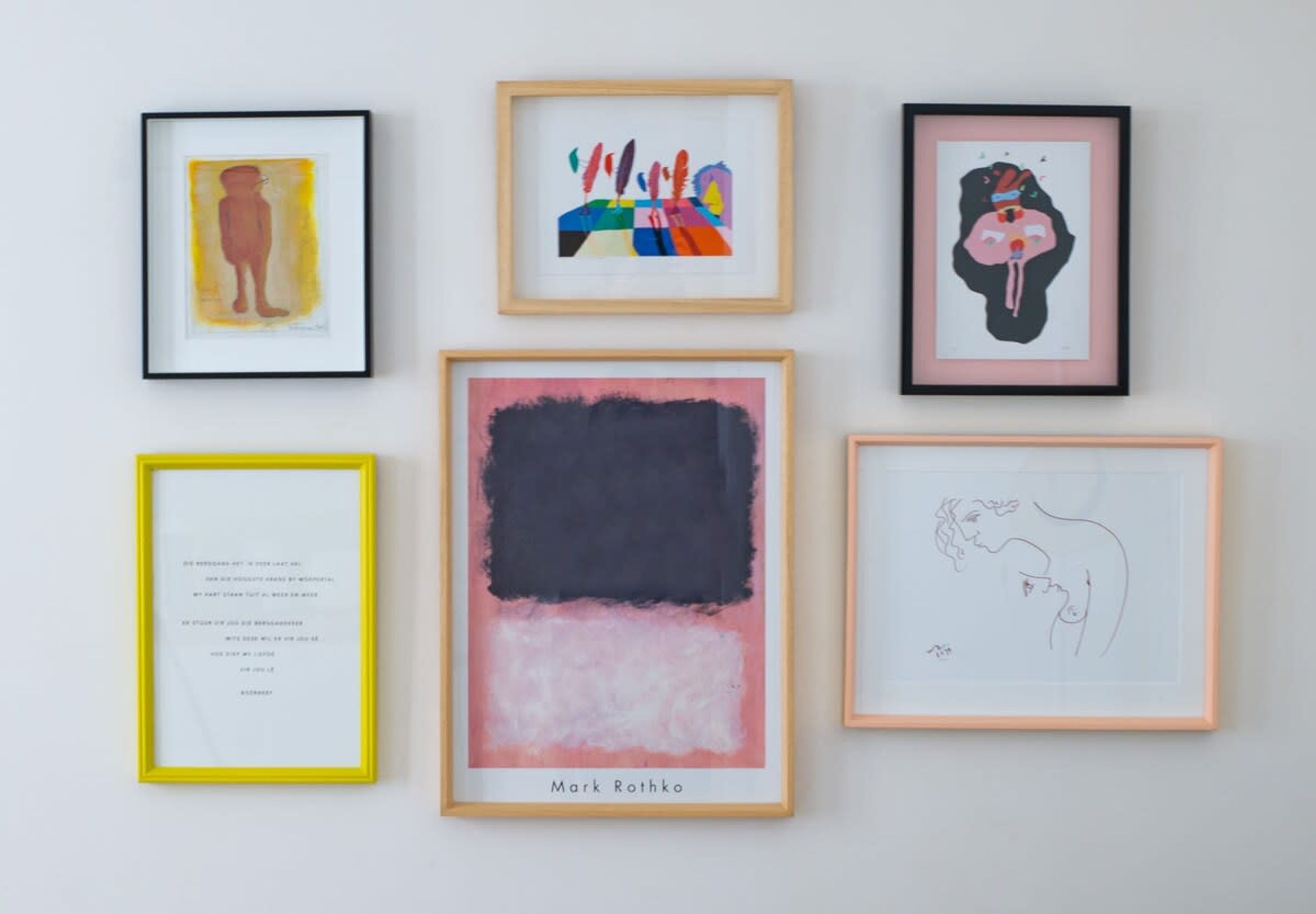 Six framed artworks on a wall.