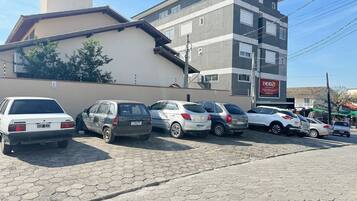 A parking lot with several cars parked in front of a building with a sign that reads "ENERGIZE".