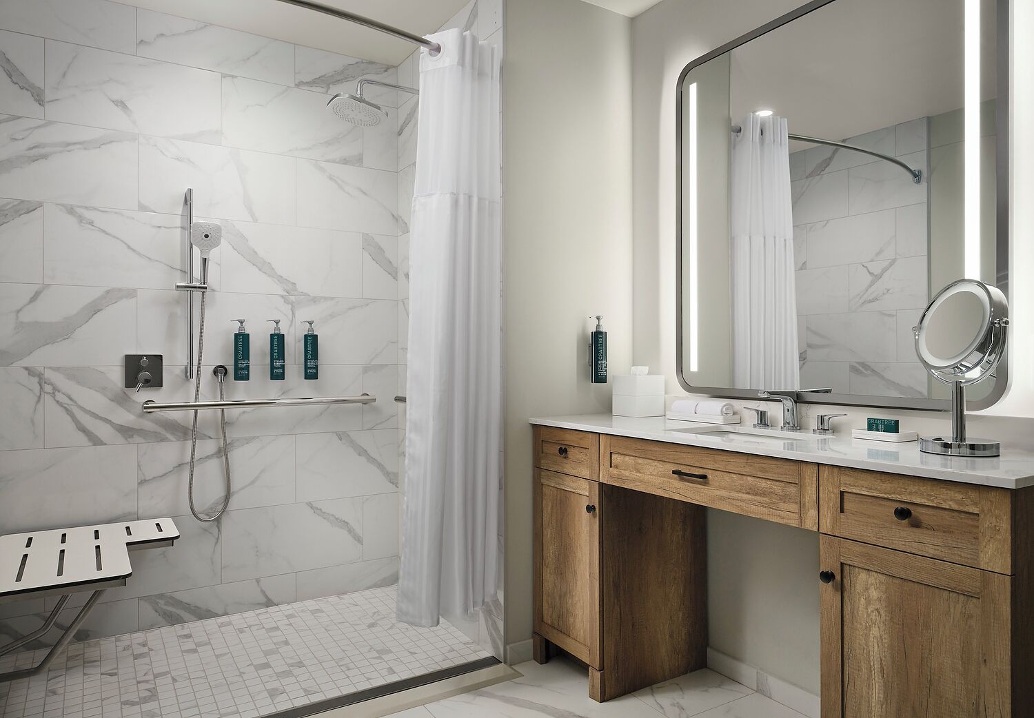 A modern bathroom with a shower, vanity, and a large mirror.