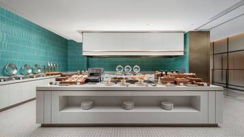 Un bufé de desayuno moderno con gran variedad de alimentos y un elegante salpicadero de azulejos.