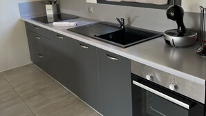 A modern kitchen with a double sink, a stove, and a built-in oven. - 1 bedroom apartment in quiet residence! Peaceful! & Always Sunny! (PROPRIANO)