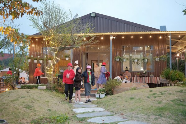 Un bâtiment de style rustique, avec une façade en bois et un espace d’entrée abrité.