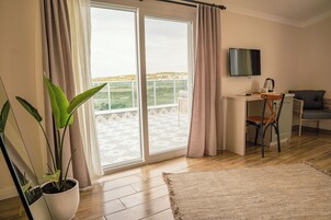 Deluxe Room, Multiple Beds, Terrace, Partial Sea View | Minibar, in-room safe, laptop workspace, soundproofing