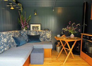 TV, fireplace - The Sett, a Stunning Shepherd’s Hut & Hot Tub (Carnforth)