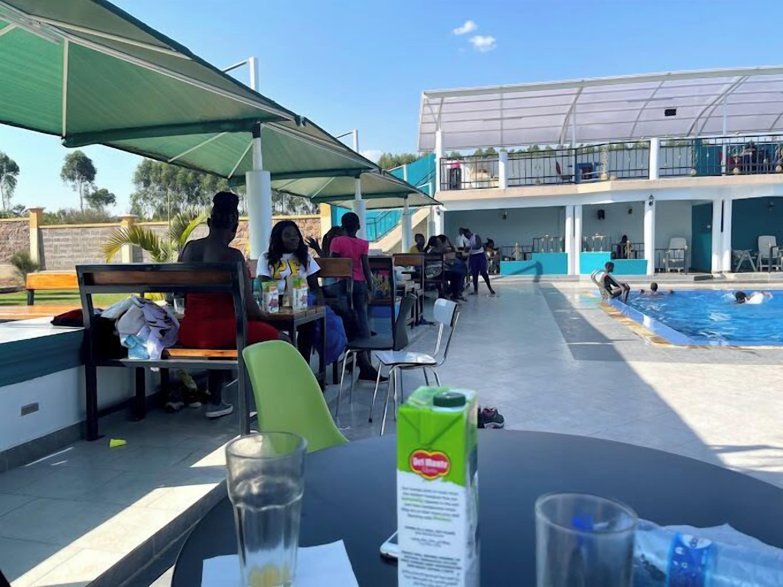 A poolside area with outdoor seating and a pool.