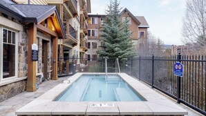 A swimming pool with a 3.5-meter depth, surrounded by a stone deck and a metal fence. - Steps to Lifts, Peak 9, Main Street Balcony, Lounge Pool Water House 5204 by Avantstay (Breckenridge)