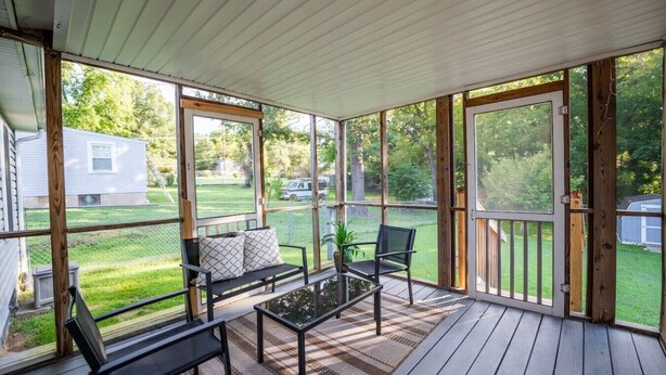 A covered porch with a bench, chairs, and a table. - Spacious 3bd/2ba near Casino (Danville)