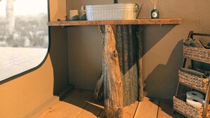 A bathroom with a wooden vanity, a mirror, and a window. - Tent Cholla, occupancy near Saguaro NP (Marana)