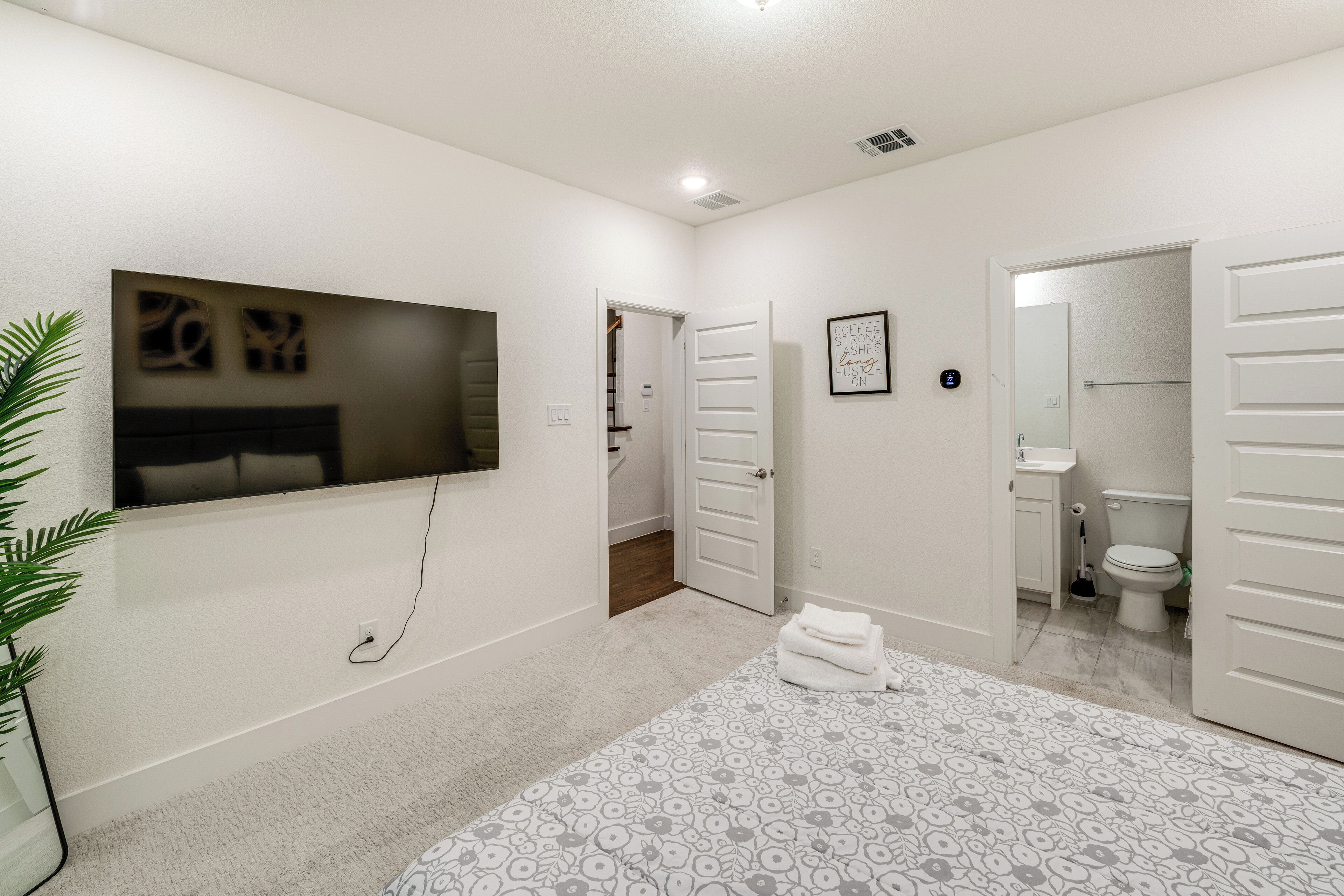 A modern bathroom with a toilet, sink, and shower.