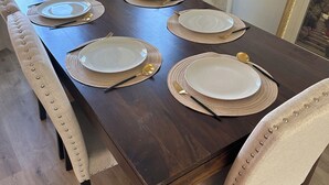 A dining table set with plates, cutlery, and placemats. - 4BR/2.5BA House in Delightful Lancaster with WiFi, AC and Large Yard (Lancaster)