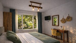 A bedroom with a bed, a desk, a TV, and a window with curtains. - MAKİA OTEL (Marmaris)