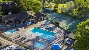 A hotel with multiple swimming pools, tennis courts, and a parking area. - Condo Near Snowbasin, 2/2 (Huntsville)