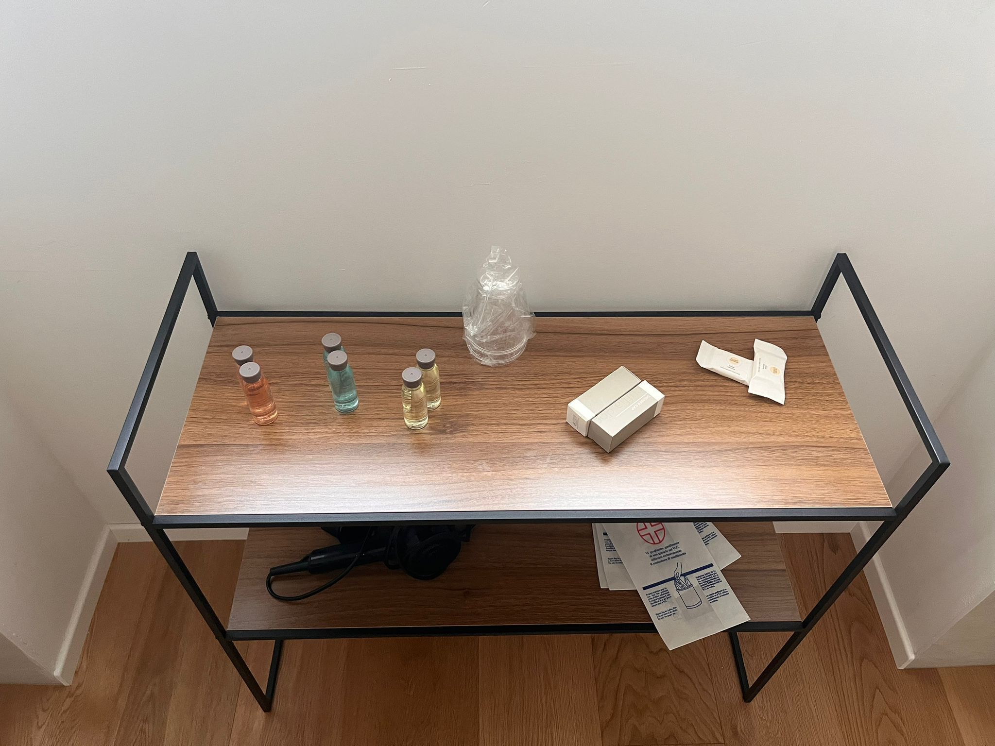 A glass-top table with various items including bottles, a vase, and a box.