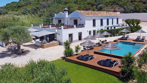 A modern villa with a swimming pool, outdoor seating, and a view of a hillside. - 1 bedroom apartment in estã´mbar (Estômbar)