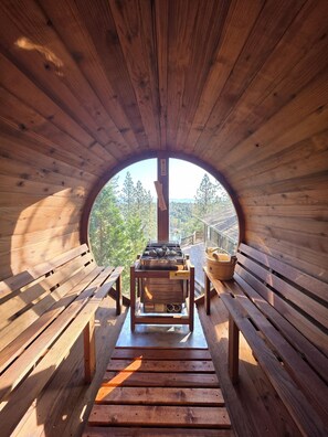 A wooden cabin with a circular window, a wooden bench, and a barbecue grill. - Stunning Lakeview Yosemite Private House with Panaromic Suna & Seasonal Hot Spa (Groveland)