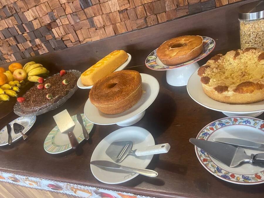Uma mesa de buffet com diversos doces e frutas.
