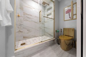 A bathroom with a glass-enclosed shower, a wooden toilet, and a marble wall. - Orlando 2BR Apt, Full Kitchen, Near Epic Universe (Orlando)
