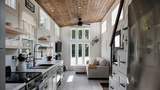 A modern kitchen with white cabinetry, a stainless steel refrigerator, and a wooden ceiling. - Shadow’s Hideaway - Tiny Home w/ Fire Pit + Views (Cleveland)