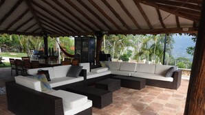 An outdoor patio with a sectional sofa, a dining table, and chairs. - TOPOWA CLUB HOUSE RESORT (Giron)