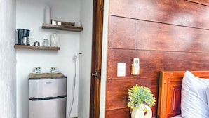 A compact kitchenette with a refrigerator, a coffee maker, and a shelf with kitchenware. -  Volcano and Lake View, Eco Glam #1. (La Fortuna)